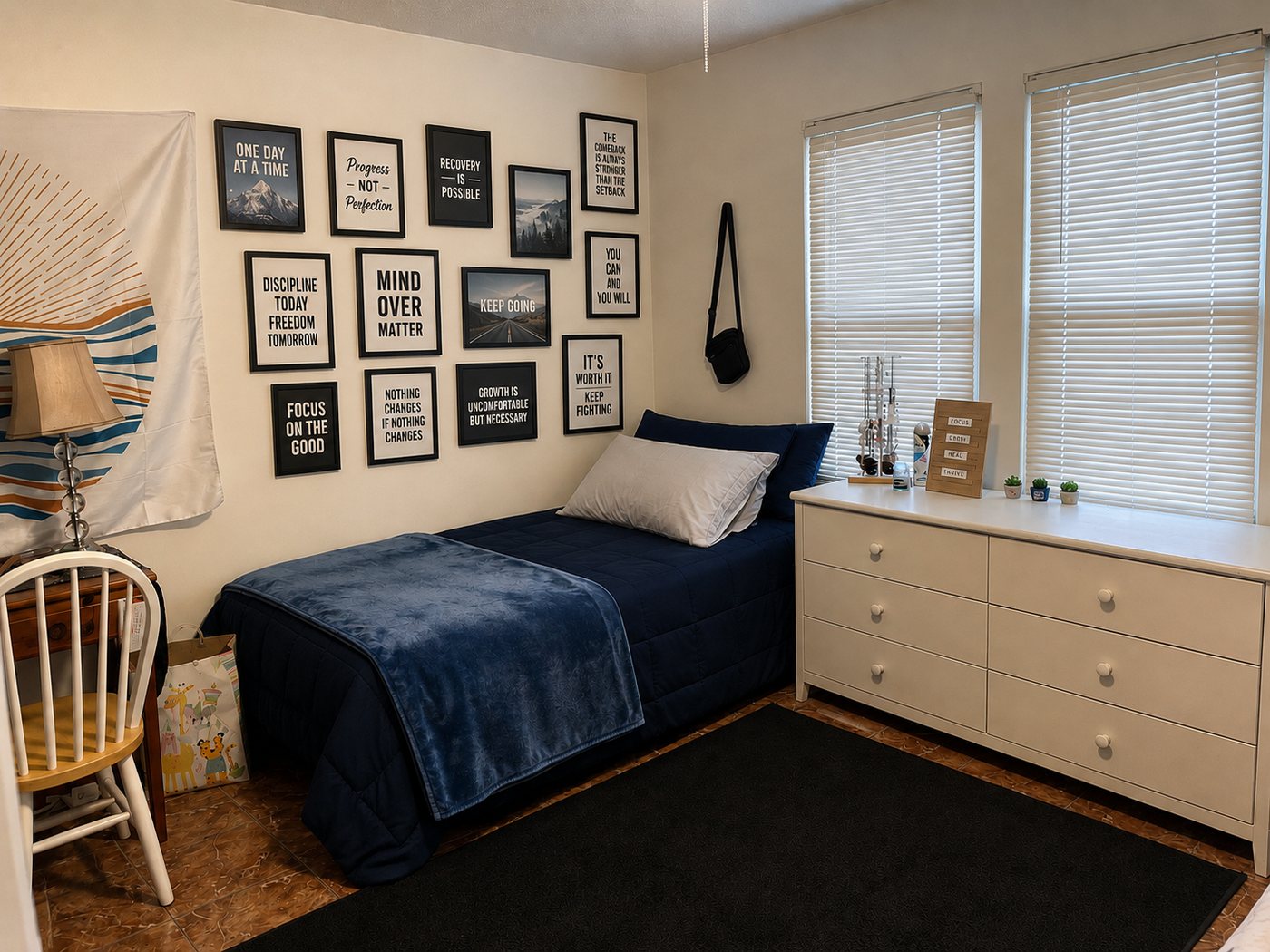 Bedroom with blue bedding and recovery wall art