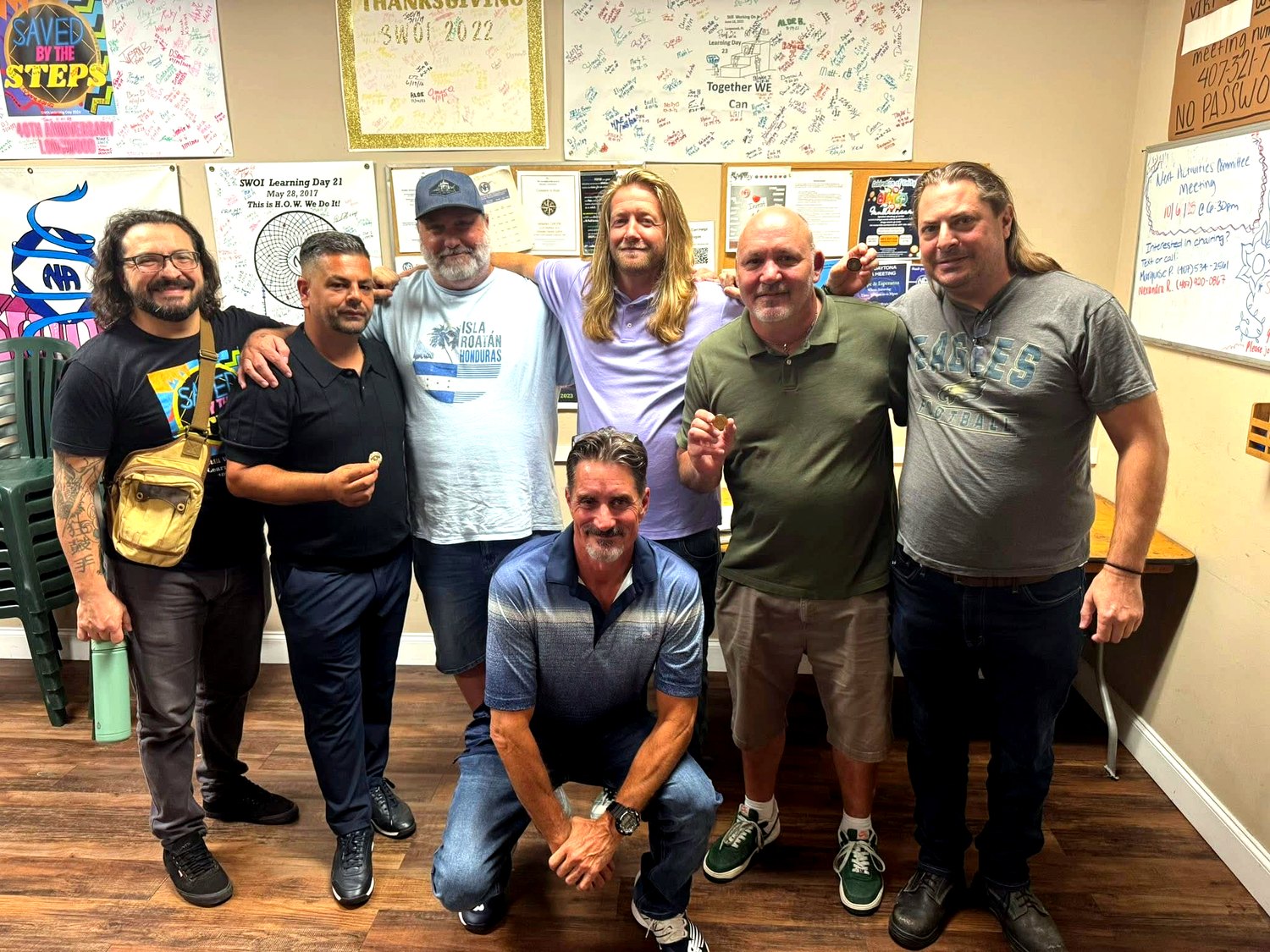 Steadfast Recovery community group photo in a meeting room