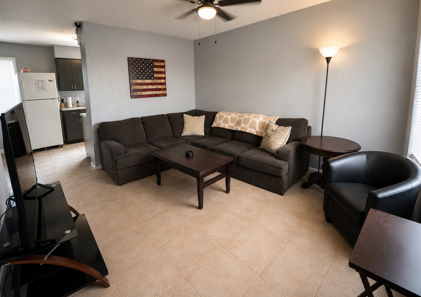 Shared living room with couch and kitchen nearby